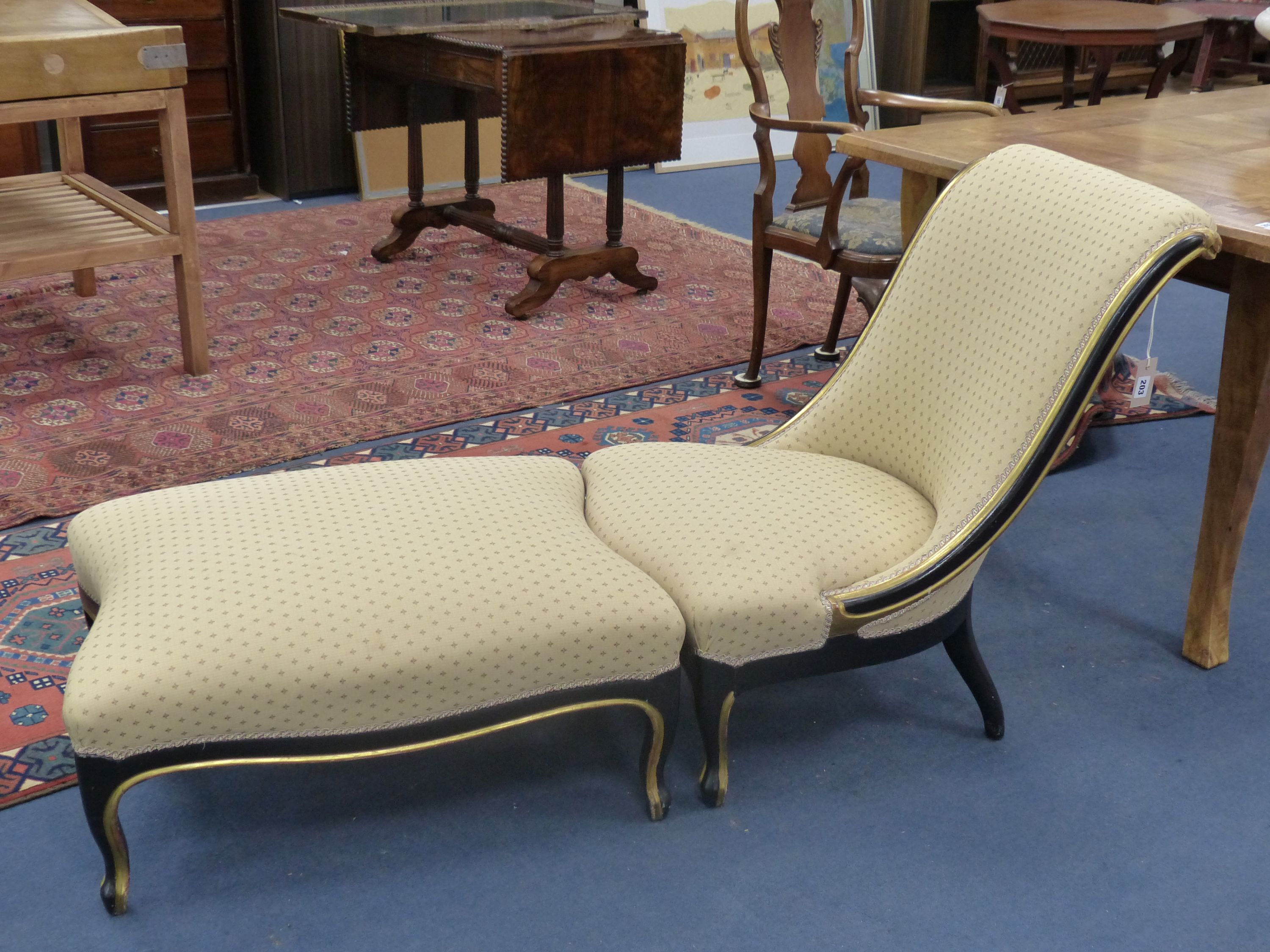 A 19th century French ebonised upholstered chair and associated stool